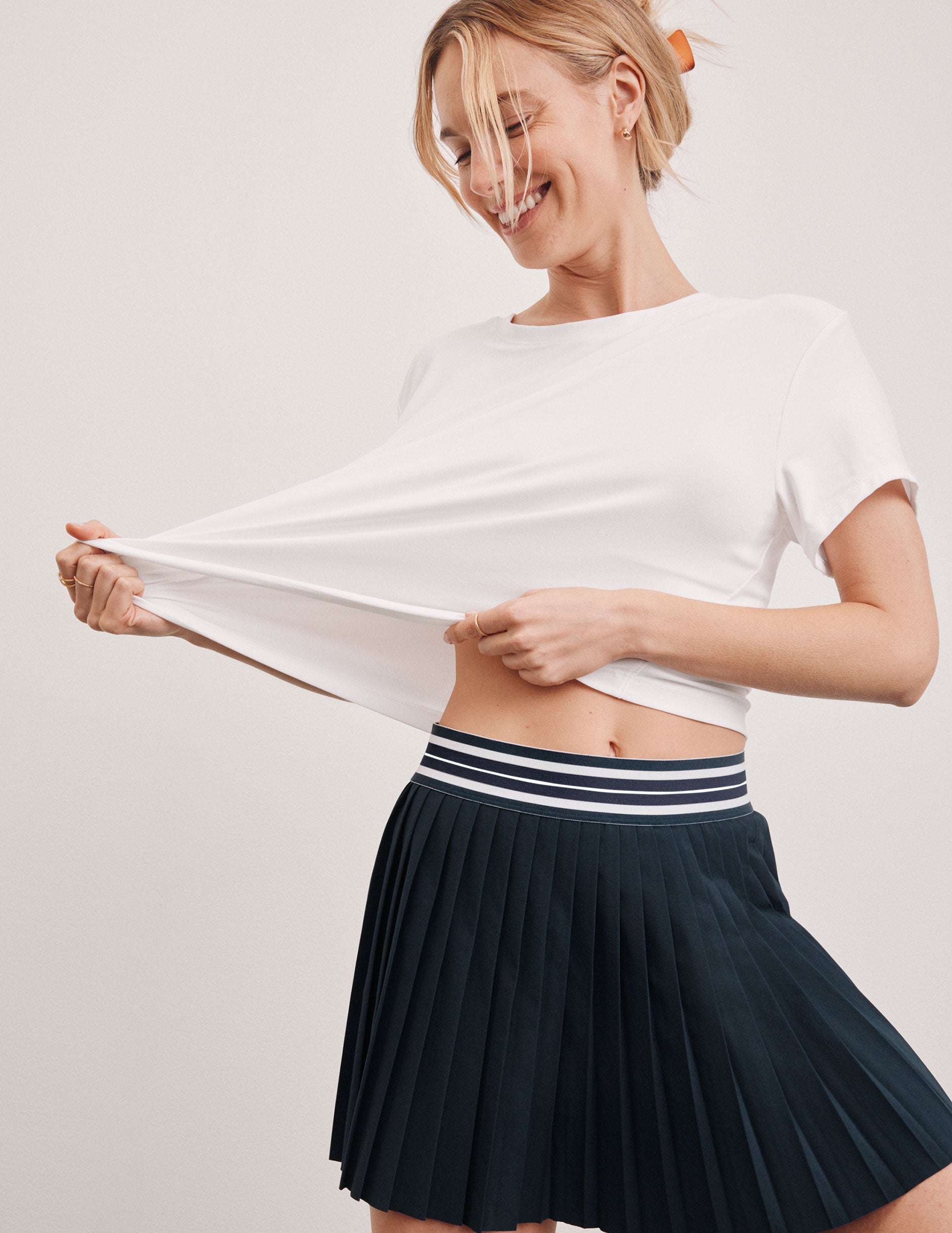 white lightweight loose-fitting cropped tee with a scoop neckline.  